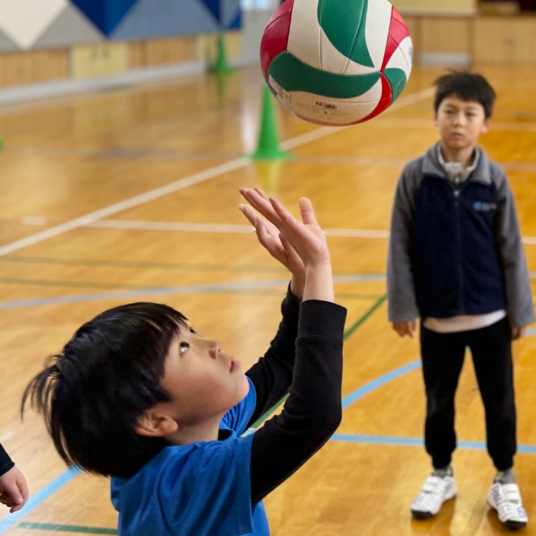 Volleyball at OWIS Osaka - Kid hitting volleyball up into the air
