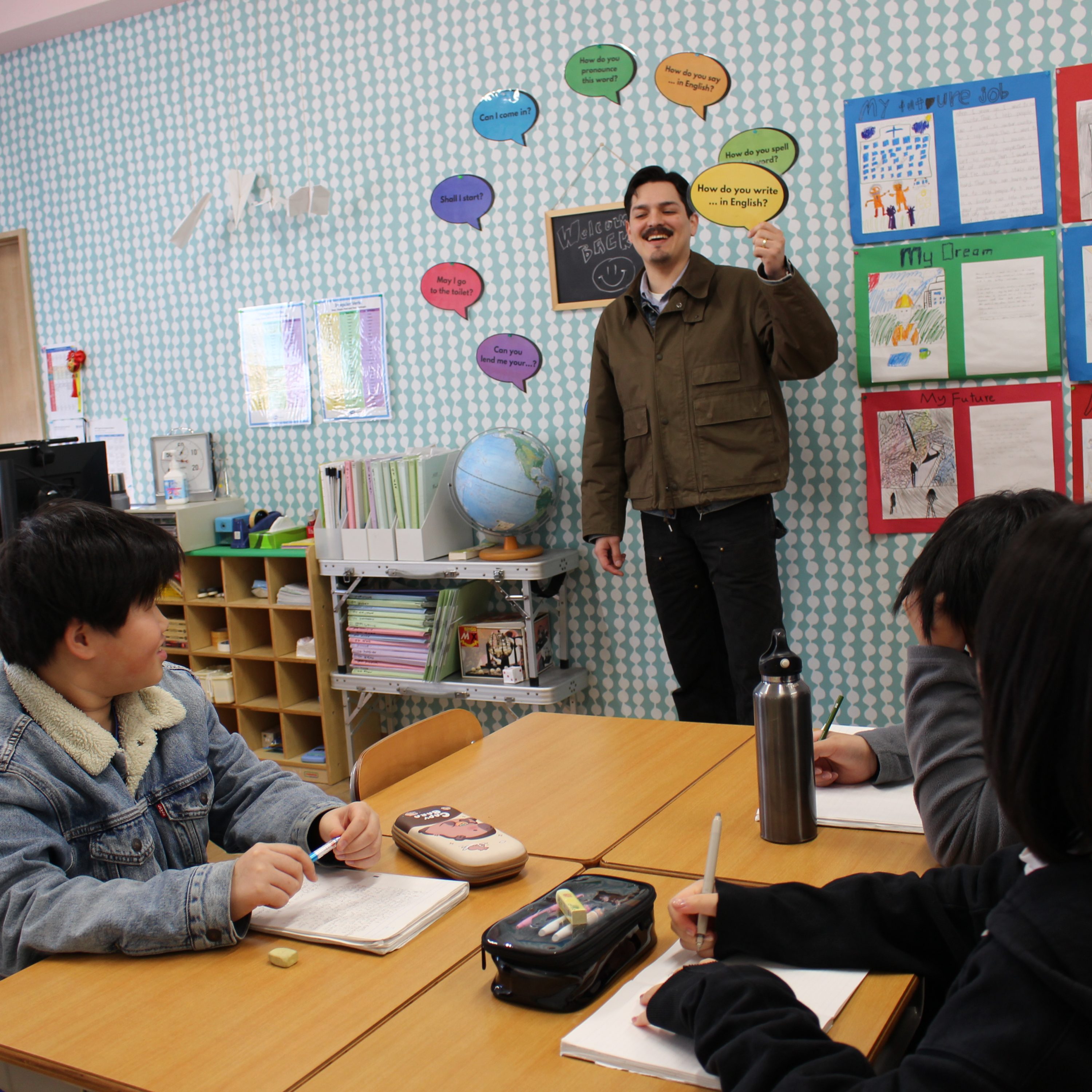 AEP teachers teaching Academic English preparation class holding speech bubble