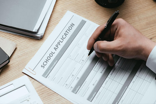 Person filling out School Admission Documents