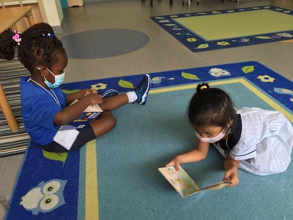 Young learners in Early Childhood at OWIS Nanyang reading storybooks | IB School in Singapore