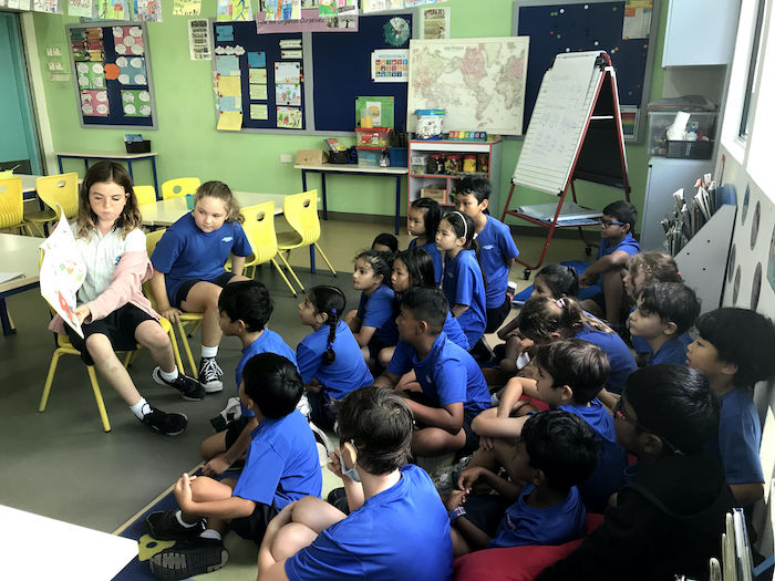 OWIS Secondary students reading aloud to Primary students | Nanyang Campus