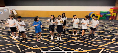 Students at OWIS Suntec practising African song for International Day