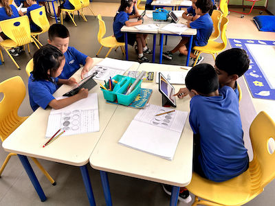 Image capturing OWIS Nanyang Primary students engaging in IBPYP curriculum activities focused on exploring the theme of space.