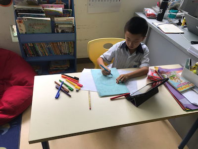 A photo depicting OWIS Nanyang Primary student actively participating in IBPYP, exploring the theme of space through hands-on activities.